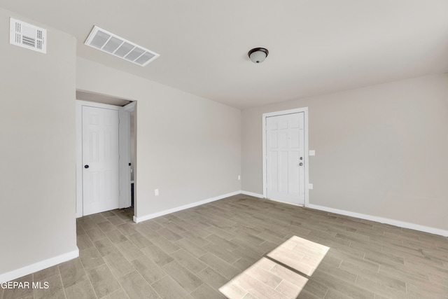 spare room with light hardwood / wood-style floors