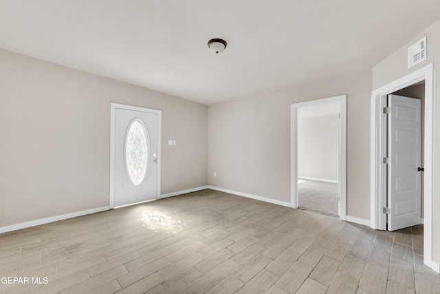 foyer entrance with light wood-type flooring