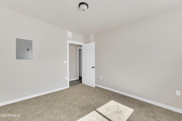 carpeted empty room featuring electric panel