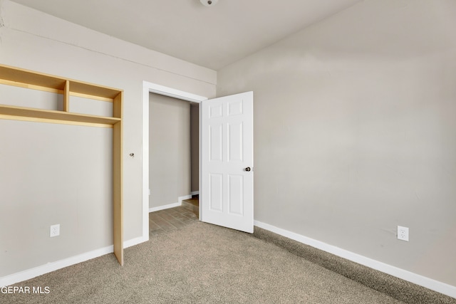 unfurnished bedroom with a closet and carpet floors