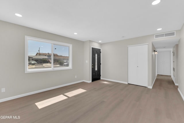 empty room with hardwood / wood-style flooring