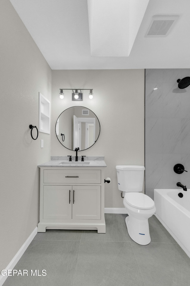 full bathroom featuring toilet, tiled shower / bath, vanity, and tile patterned flooring