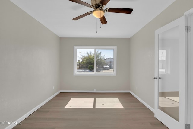 spare room with ceiling fan and dark hardwood / wood-style flooring