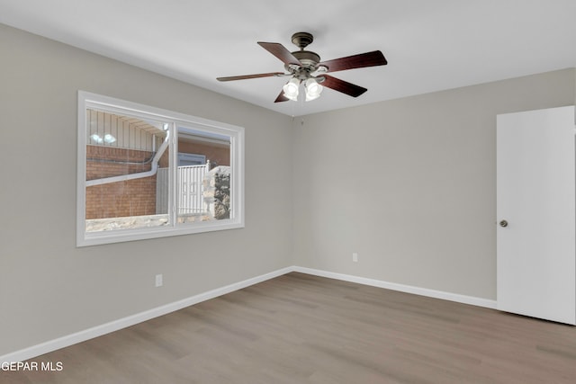 unfurnished room featuring hardwood / wood-style flooring and ceiling fan