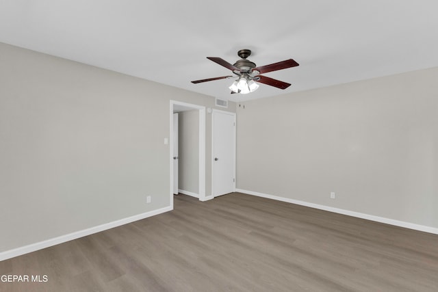 empty room with hardwood / wood-style floors and ceiling fan