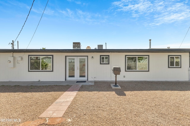 rear view of house featuring french doors and central AC unit