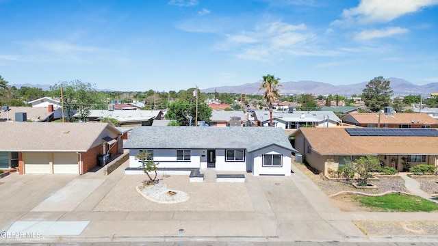 view of front facade featuring a mountain view and a garage