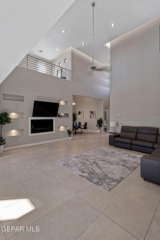 tiled living room featuring a high ceiling