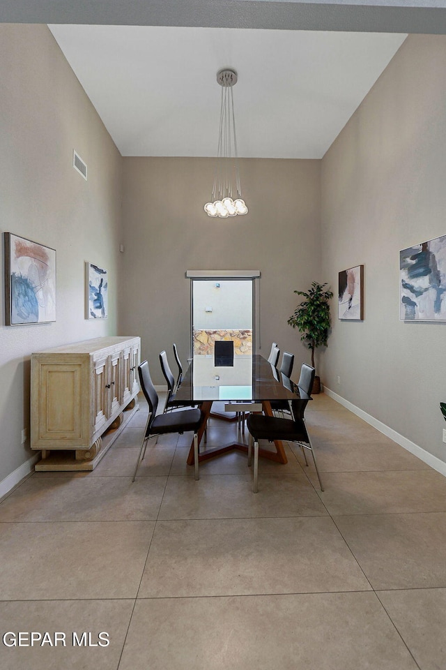 dining space with light tile patterned floors and a chandelier