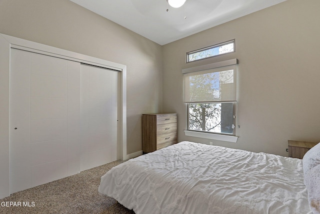 carpeted bedroom featuring a closet and ceiling fan