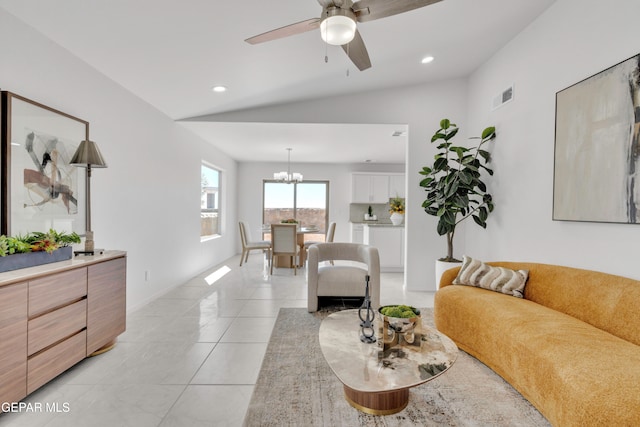 tiled living room featuring lofted ceiling and ceiling fan with notable chandelier