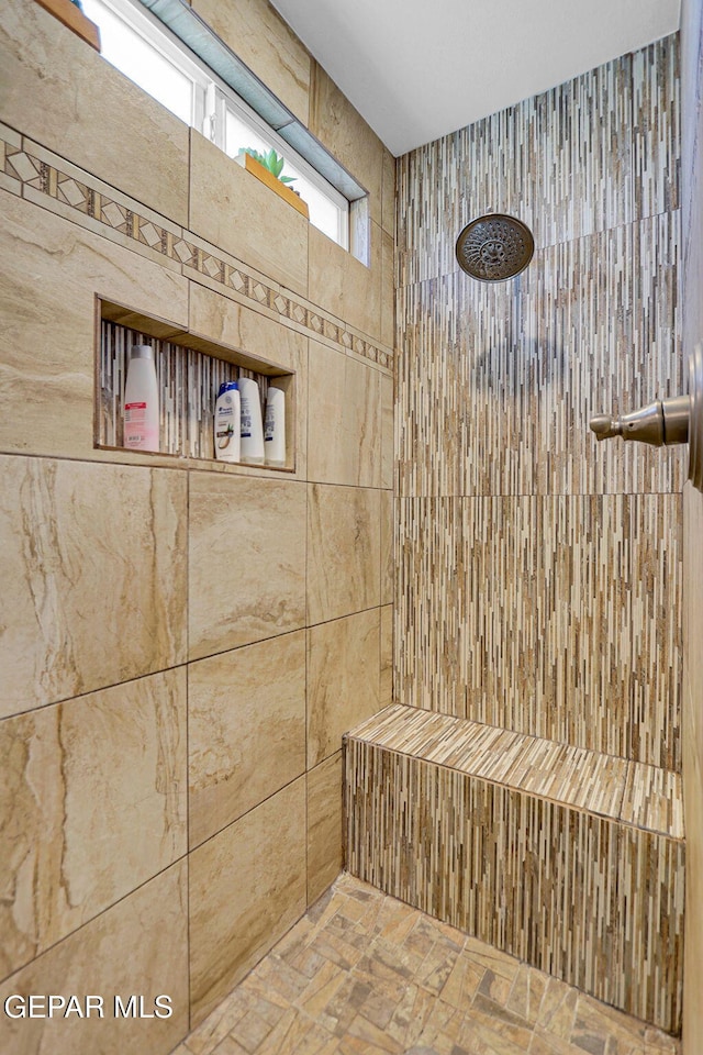 bathroom featuring a tile shower