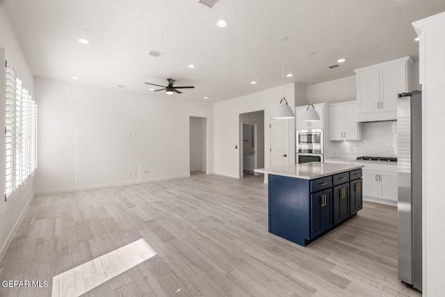 13397 Highworth Dr, El Paso, TX 79928 - kitchen with white cabinets, ceiling fan, light countertops, stainless steel appliances, and a kitchen island