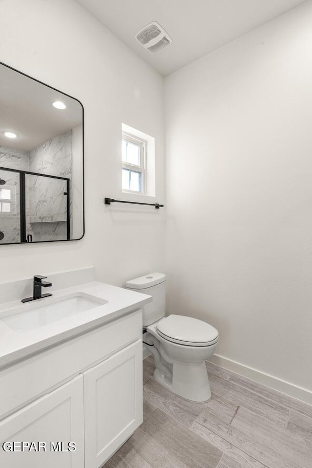 13397 Highworth Dr, El Paso, TX 79928 - bathroom featuring vanity, toilet, baseboards, a shower stall, and visible vents