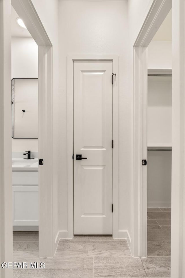 13397 Highworth Dr, El Paso, TX 79928 - hall with baseboards, a sink, and light wood-style flooring