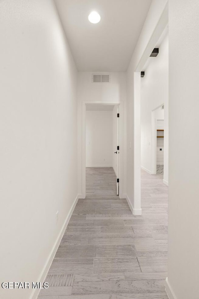 13397 Highworth Dr, El Paso, TX 79928 - hallway with baseboards, light wood-style flooring, and visible vents
