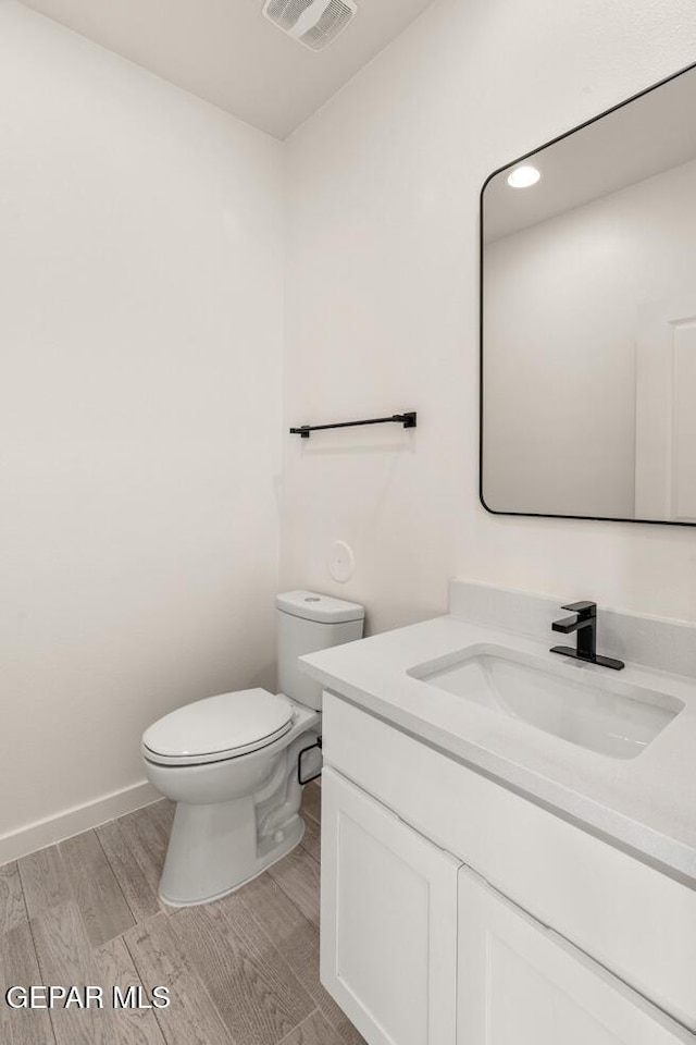 13397 Highworth Dr, El Paso, TX 79928 - bathroom featuring vanity, toilet, recessed lighting, wood finished floors, and visible vents