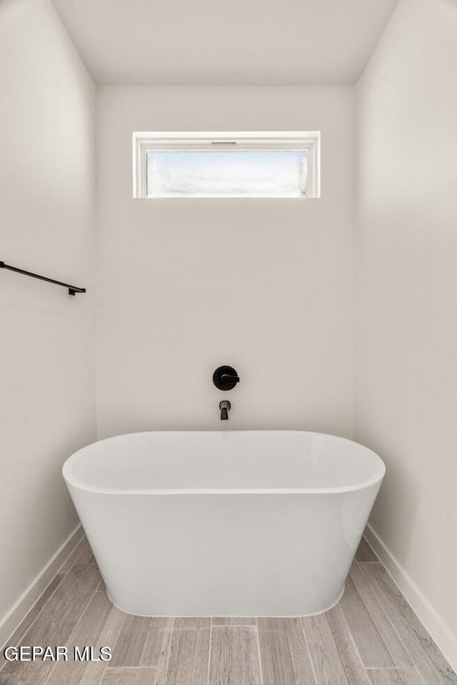 13397 Highworth Dr, El Paso, TX 79928 - full bathroom featuring a freestanding tub, a wealth of natural light, and wood finished floors