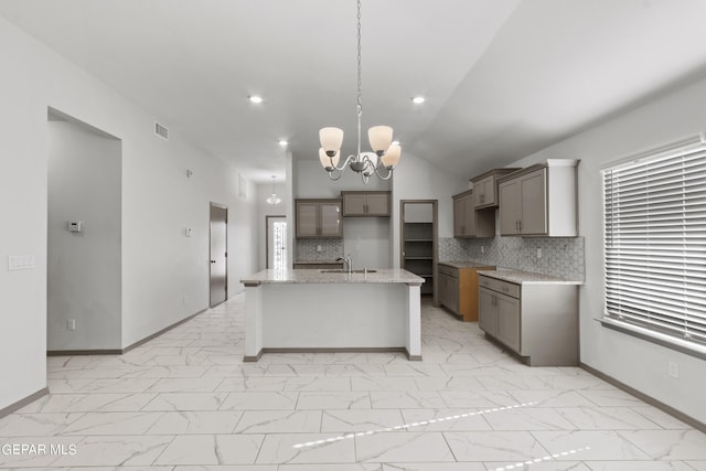 1229 Night Sky St, El Paso, TX 79928 - kitchen featuring a sink, light marble finish floors, backsplash, a chandelier, and baseboards