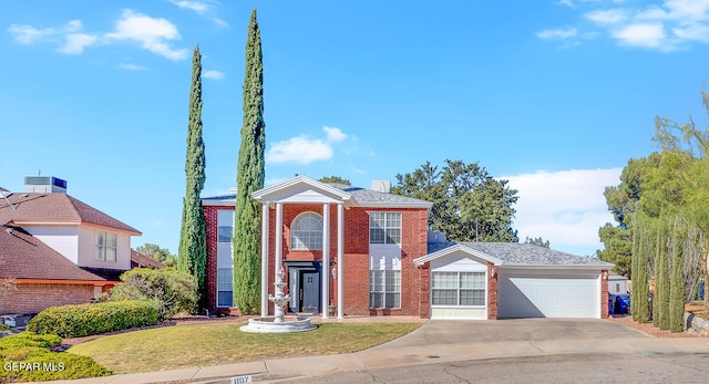 view of front of home with a front yard and a garage