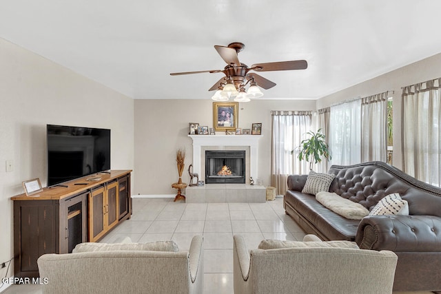 tiled living room with a fireplace and ceiling fan