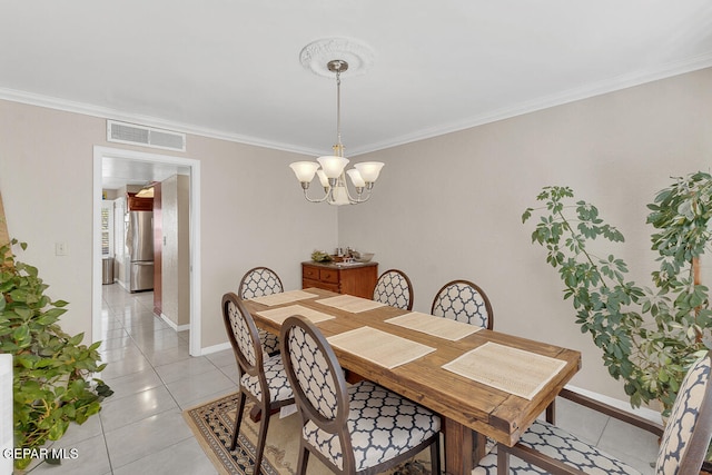 tiled dining area featuring crown molding and a notable chandelier