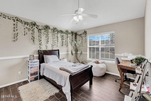 bedroom featuring dark wood-type flooring, ceiling fan, and a textured ceiling