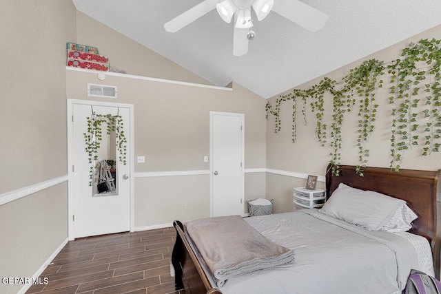 bedroom featuring ceiling fan, high vaulted ceiling, a textured ceiling, and dark hardwood / wood-style floors