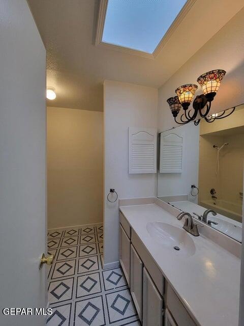 bathroom with vanity, tile patterned floors, and a skylight