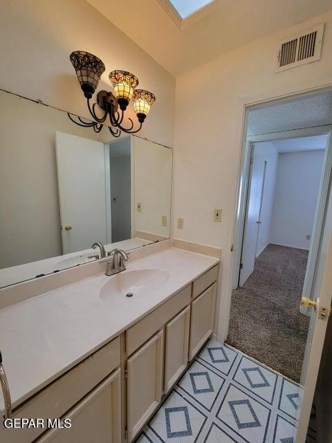 bathroom with vanity and a skylight