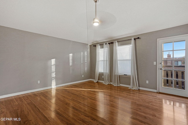 unfurnished room with a textured ceiling and hardwood / wood-style flooring