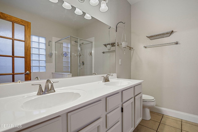 bathroom featuring toilet, walk in shower, vanity, and tile patterned floors