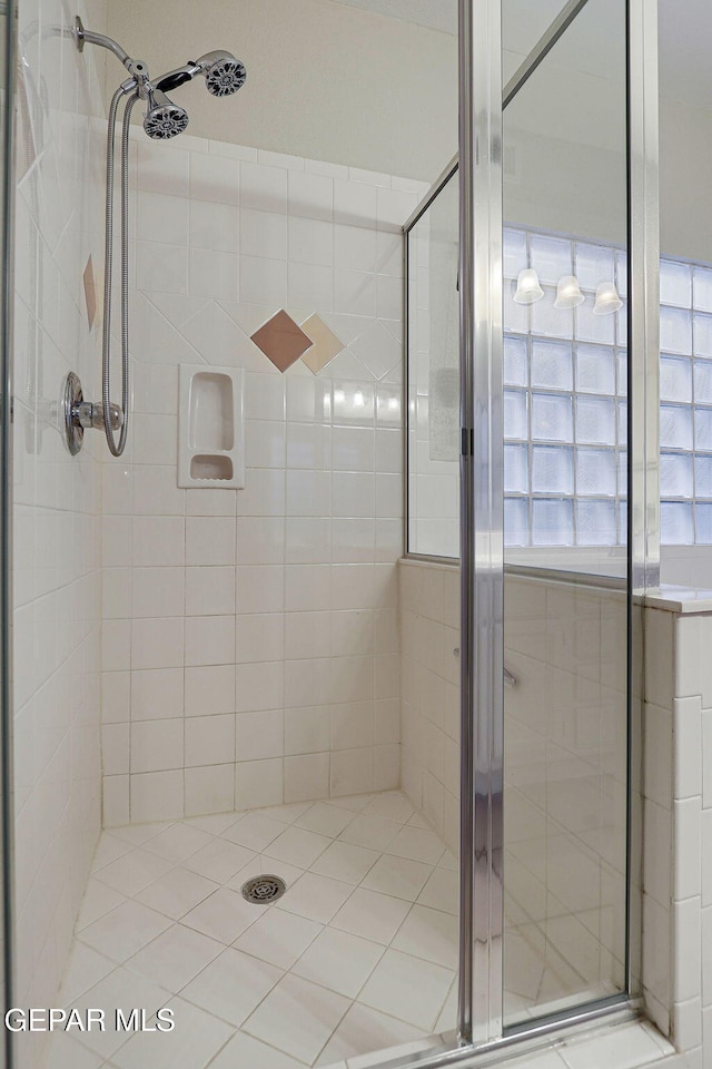 bathroom featuring a shower with shower door