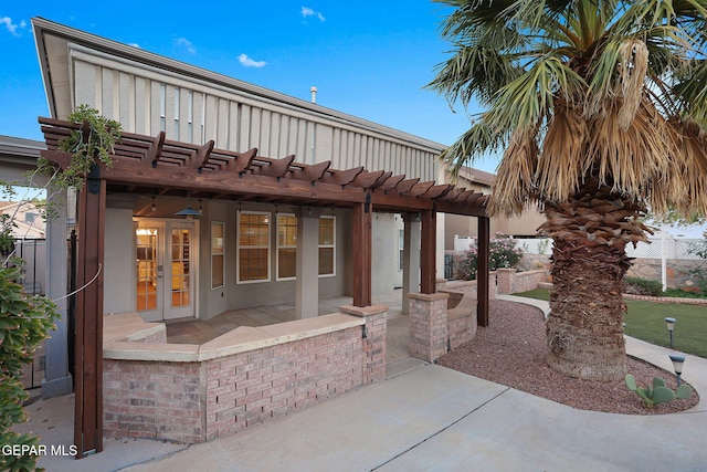 view of patio / terrace featuring french doors and a pergola