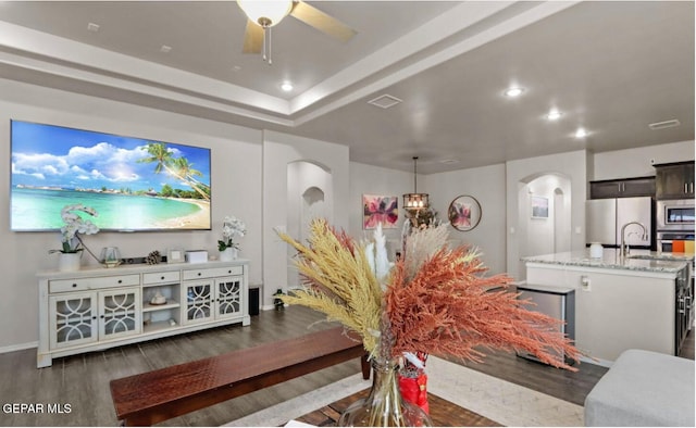 living room featuring dark hardwood / wood-style floors and ceiling fan