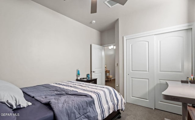 carpeted bedroom featuring ceiling fan and a closet