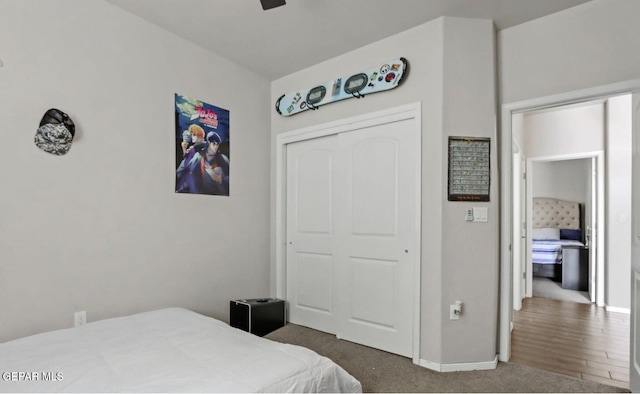 bedroom with dark carpet and a closet