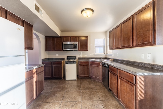 kitchen with sink, white appliances, and tile patterned flooring