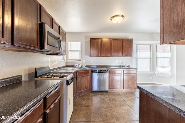 kitchen featuring sink, stainless steel appliances, and light tile patterned floors