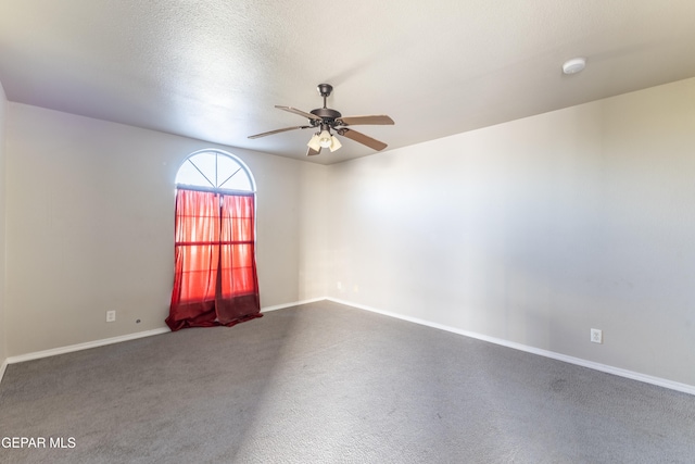 carpeted spare room featuring a textured ceiling and ceiling fan