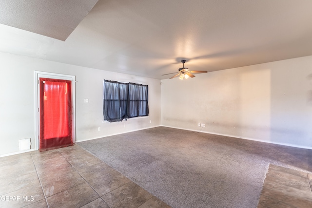 unfurnished room featuring carpet floors, a textured ceiling, and ceiling fan