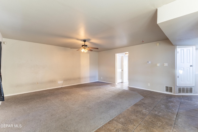 empty room featuring dark carpet and ceiling fan