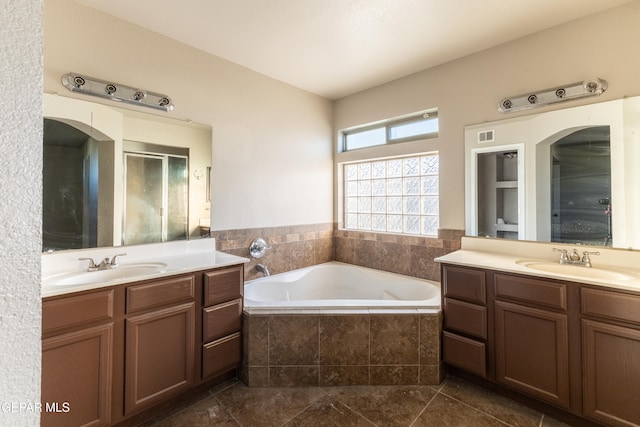 bathroom featuring vanity, tile patterned floors, and plus walk in shower