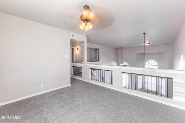 carpeted empty room featuring ceiling fan