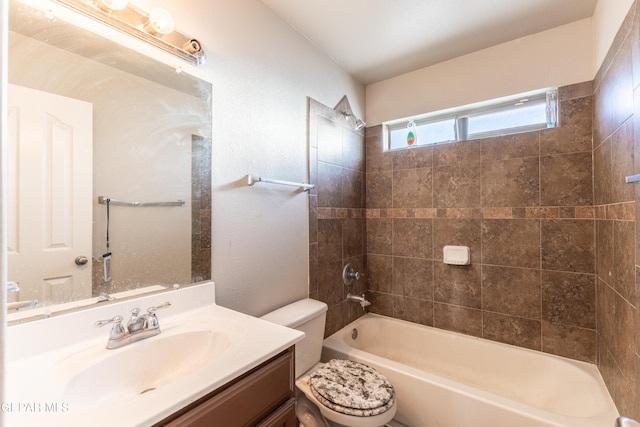 full bathroom with toilet, tiled shower / bath combo, and vanity