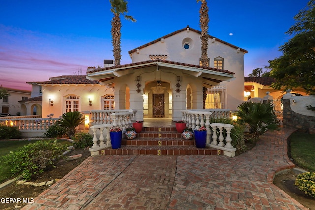 mediterranean / spanish house with covered porch