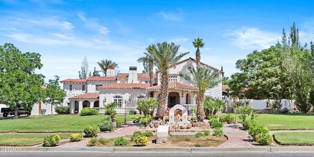 mediterranean / spanish house featuring a front yard