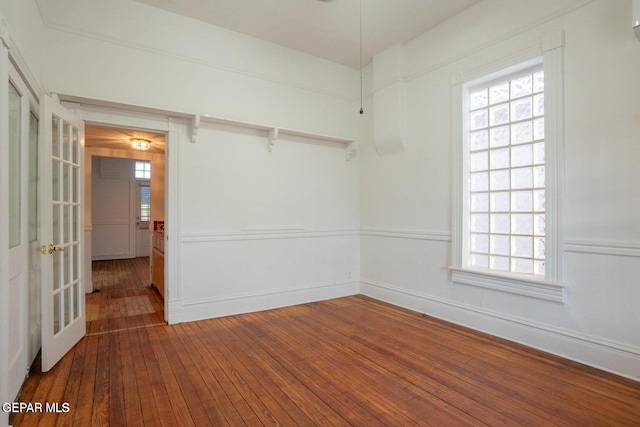 unfurnished room featuring french doors and dark hardwood / wood-style floors