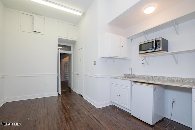 kitchen with white cabinetry, sink, and dark hardwood / wood-style floors