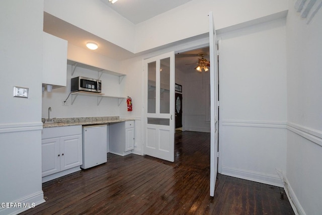 kitchen featuring white cabinetry, dishwasher, ceiling fan, sink, and dark hardwood / wood-style flooring